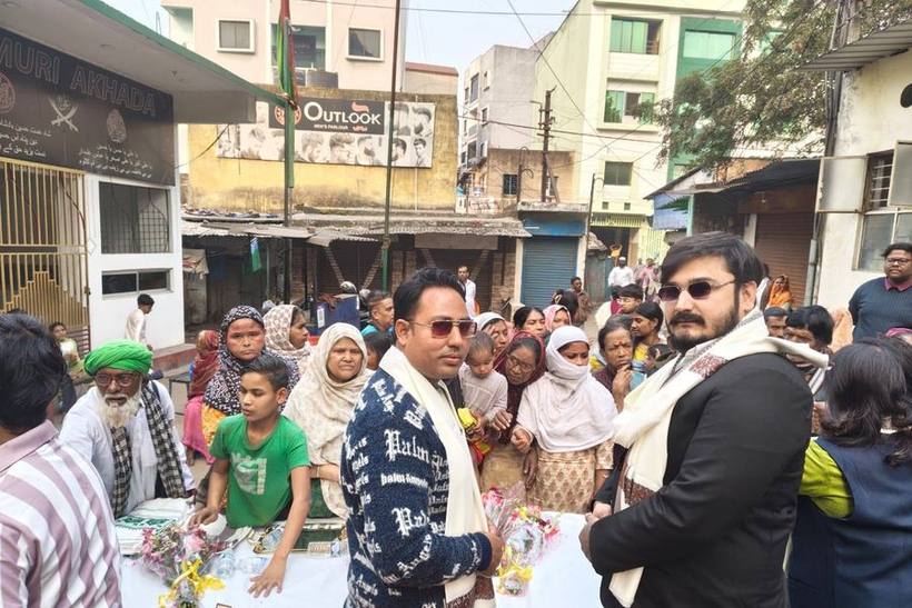 Families gathering as blankets, clothing and essentials are given out.